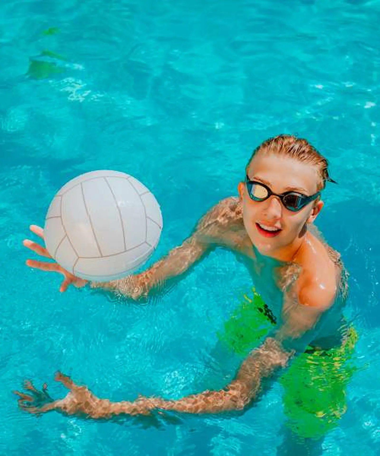 Guests playing volleyball in the pool